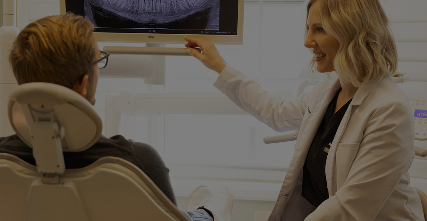 Dentist consulting with patient in modern dental office